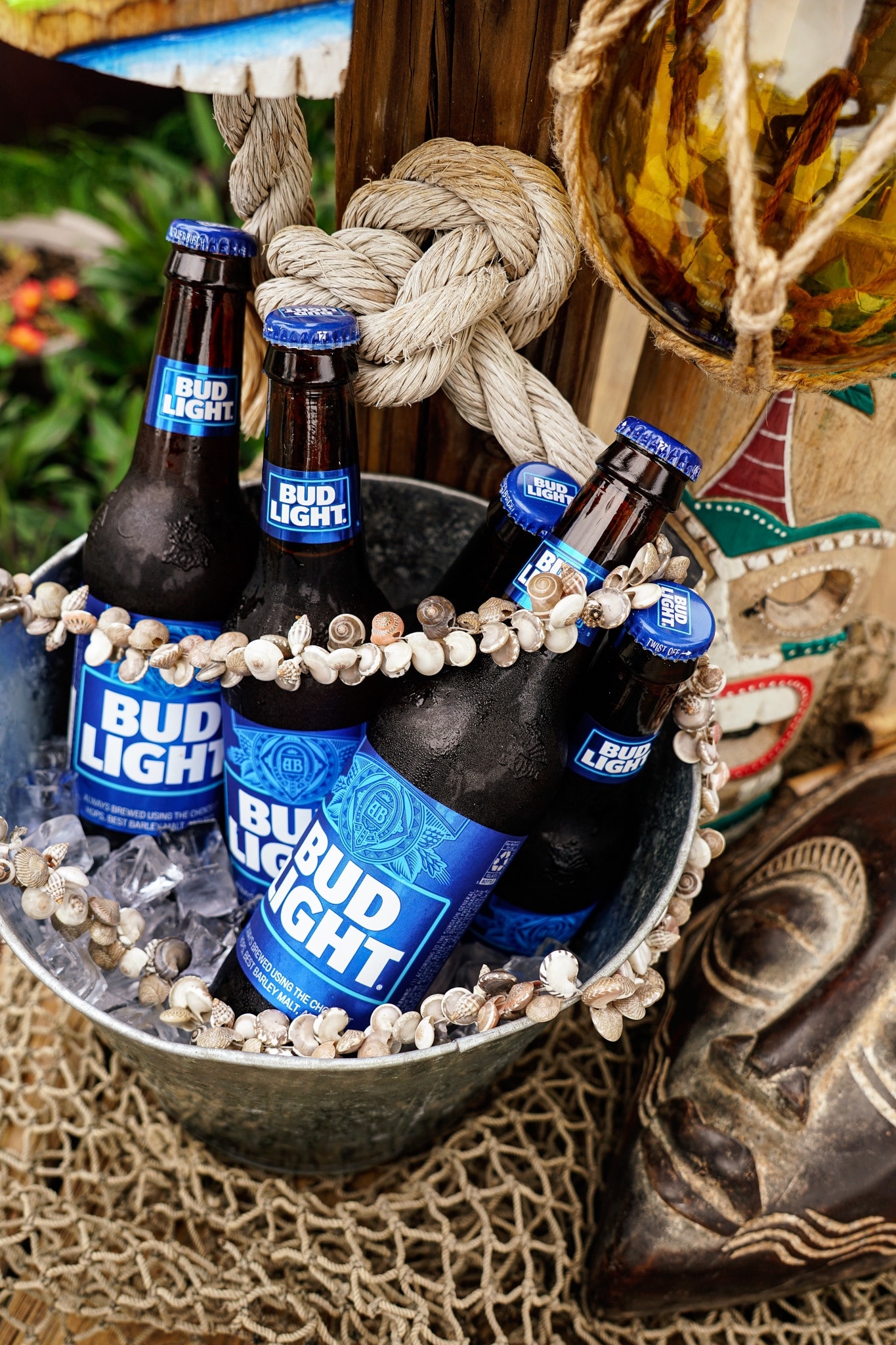 Bud Light bottles styled with rope, shells, and tiki decor at Lake Mary Pub