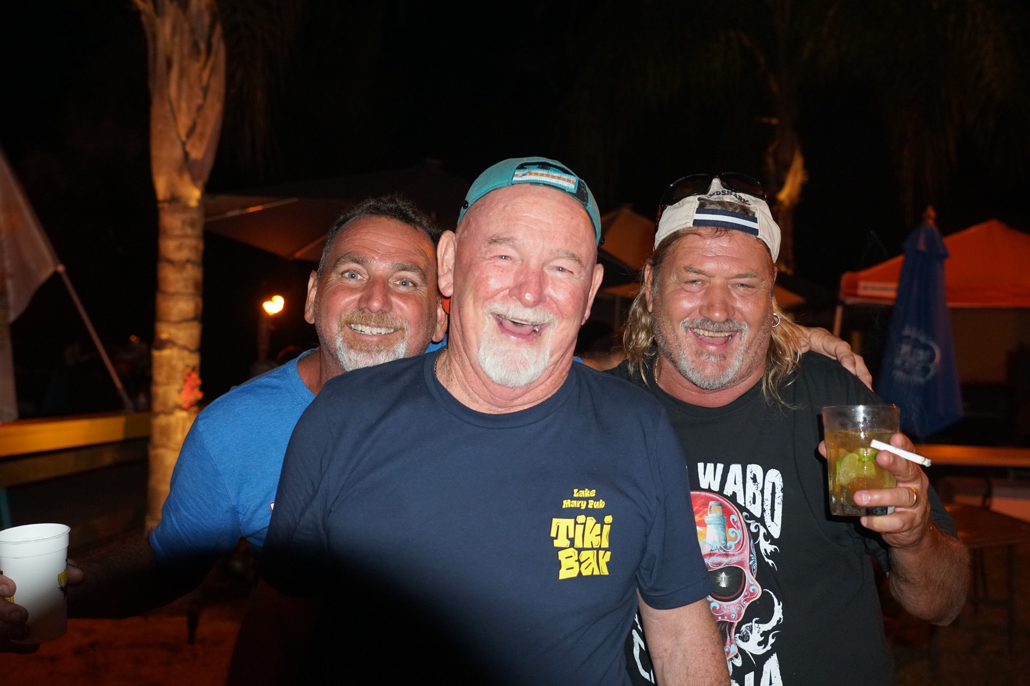 Three longtime friends together at the Lake Mary Pub tiki bar