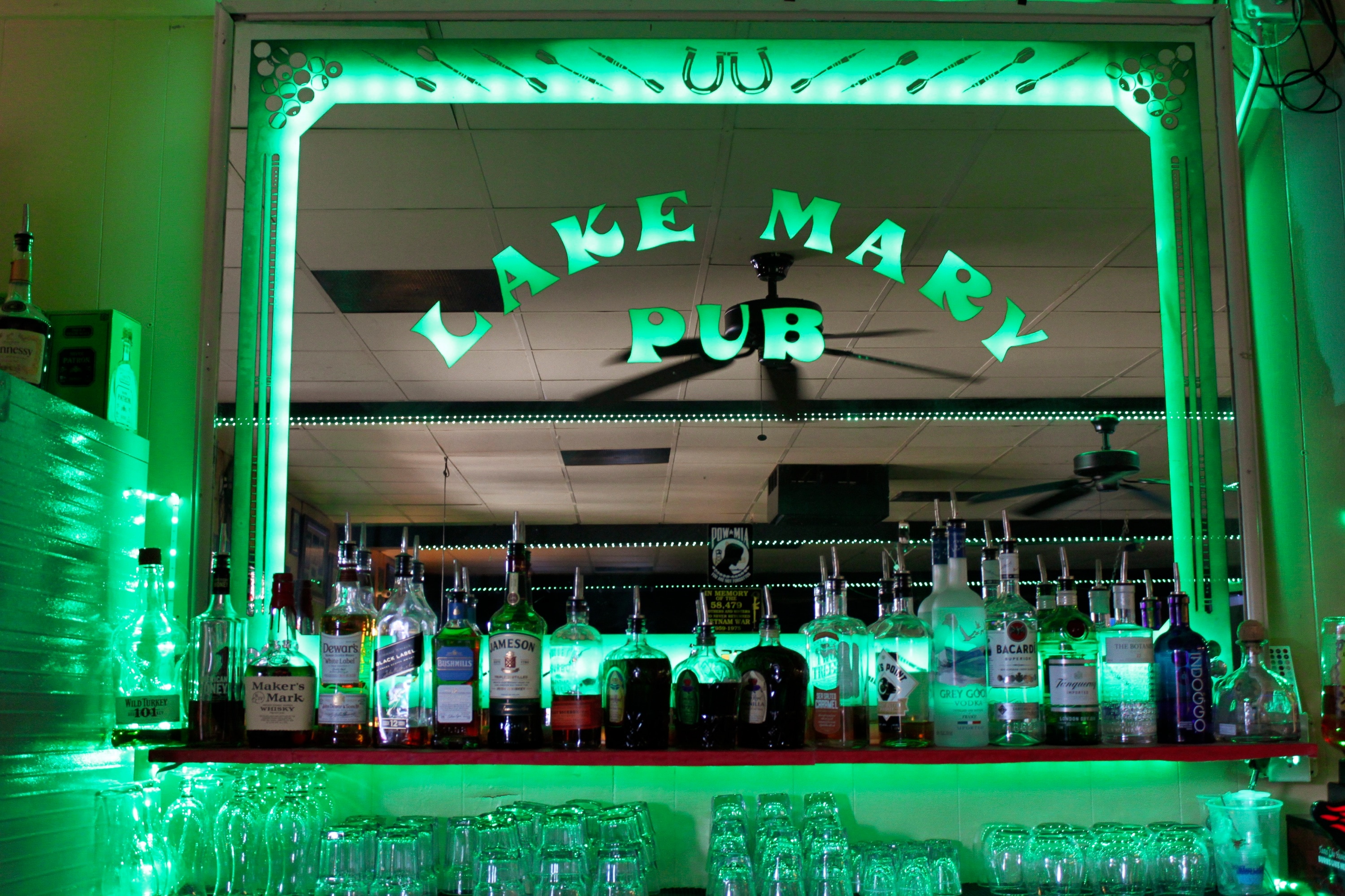 Lake Mary Pub bar reflected in its green illuminated mirror