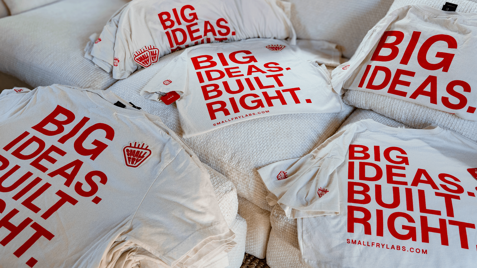 Small Fry Labs first merchandise drop laid out across a couch
